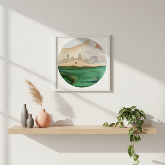 Framed artwork of a landscape with hills and a cityscape, on a white wall above a wooden shelf.