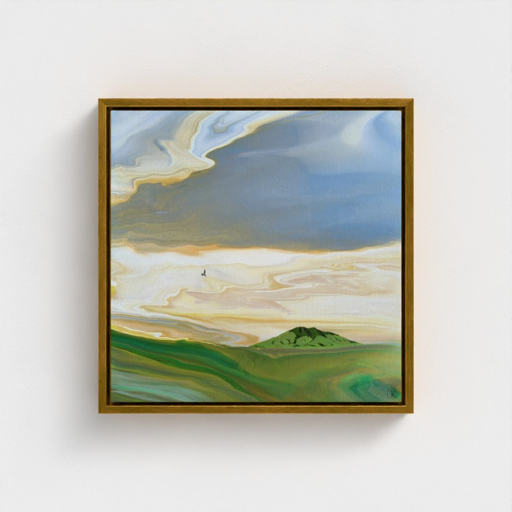 Framed painting of a landscape with green fields and a blue sky.